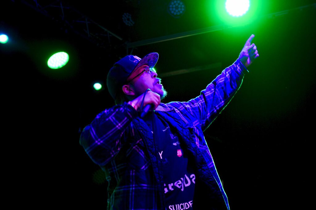 Anthony "Jinx" Jenkins performing under green stage lights